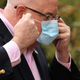 Maryland Gov. Larry Hogan replaces his surgical mask after talking to reporters during a news briefing in front of the Maryland State House April 17, 2020 in Annapolis, Maryland.